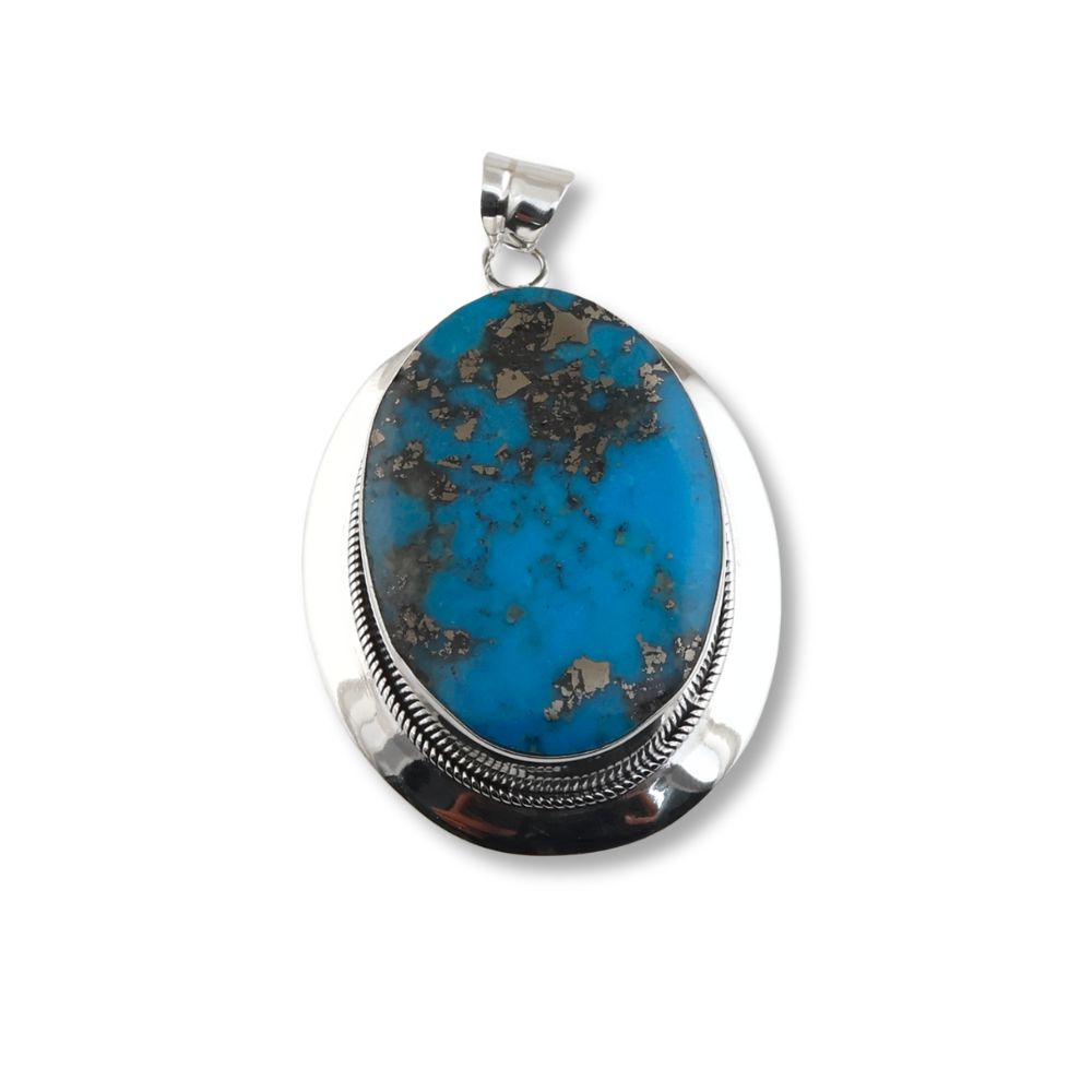 Enhance your style with our Oval Turquoise Pendant. This classic and timeless piece is expertly handcrafted to add elegance to any outfit. Shop now!